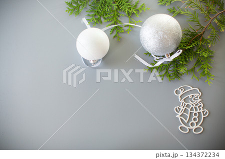 Winter card with a fir branch and a New Year's decoration 134372234
