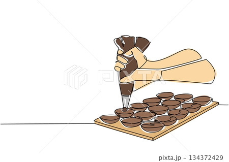Continuous line drawing illustration of hands filling chocolate shells with ganache, celebrating National Chocolate Macaron Day in a food concept with elegant minimal style 134372429