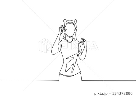 A woman applies facial serum with dropper in single line drawing style, reflecting beauty and wellness business concept, skincare rituals, and honoring natural care for National Clean Beauty Day. A woman applies facial serum with dropper in single line drawing style, reflecting beauty and wellness business concept, skincare rituals, and honoring natural care for National Clean Beauty Day. 134372890