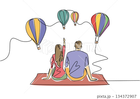 Single line drawing of couple sit and watch colorful hot air balloons conveys love and travel concept under Hot Air Balloon Day, representing romance, adventure, and scenic international celebration Single line drawing of couple sit and watch colorful hot air balloons conveys love and travel concept under Hot Air Balloon Day, representing romance, adventure, and scenic international celebration 134372907