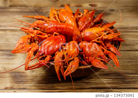 Boiled crayfish in plate on wooden table 134373091
