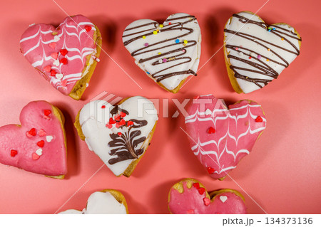 Heart shaped cookies on pink background. Top view. Dessert for Valentine day Heart shaped cookies on pink background. Top view. Dessert for Valentine day 134373136