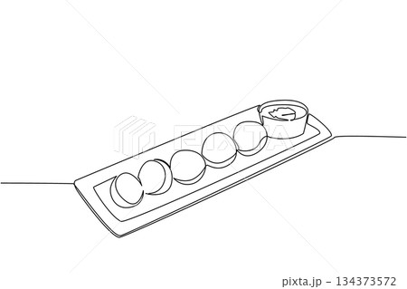 One line drawing of a long tray of falafel with tahini cup, an international event concept for International Falafel Day and, celebrating crunchy bites, pita wraps, and casual sharing 134373572