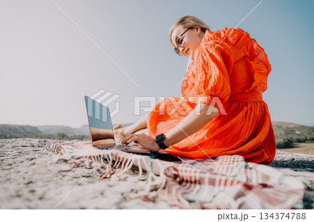 Young Woman Working on Laptop in Nature 134374788