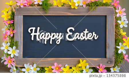 A frame with the inscription "Happy Easter" surrounded by bright spring flowers and greenery. 134375898