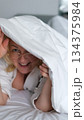 Playful cozy bed face happy woman laughing smiling rejoice flirt girl looking duvet peek toothy dental smile bedroom home pleasure tenant glad enjoying joy bed positive dentistry delight homeowner 134375984