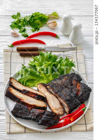 charred pork chunk served on a white platter charred pork chunk served on a white platter 134377067