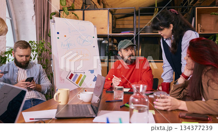 Team in collaboration meeting around table in contemporary office. Team in collaboration meeting around table in contemporary office. 134377239
