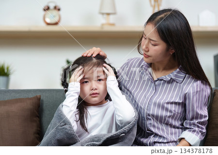 Caring Mother Comforting Sick Child at Home Caring Mother Comforting Sick Child at Home 134378178