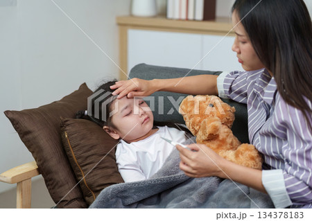 Mother Comforting Sick Child with Teddy Bear Mother Comforting Sick Child with Teddy Bear 134378183
