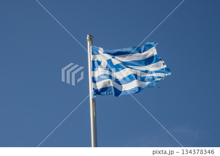 Greek flag and a blue sky, Paxos, Greece Greek flag and a blue sky, Paxos, Greece 134378346
