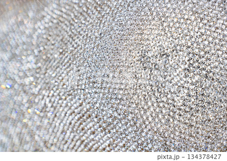Closeup detail of luxury shiny synthetic diamonds neatly arranged for making jewelry accessories. 134378427