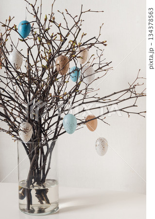 Easter branches in vase with hanging eggs 134378563