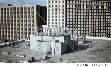 A vibrant city rooftop scene features communication towers surrounded by tall buildings. Sunlight casts playful shadows on the concrete, highlighting the busy urban atmosphere. A vibrant city rooftop scene features communication towers surrounded by tall buildings. Sunlight casts playful shadows on the concrete, highlighting the busy urban atmosphere. 134378816
