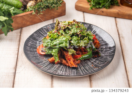 Spicy chicken salad with greens and vegetables 134379243