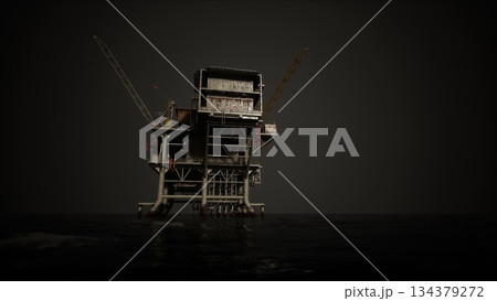 An offshore oil drilling rig stands tall against a darkening sky. The structure is surrounded by calm waters, highlighting its industrial design and significance in energy production. An offshore oil drilling rig stands tall against a darkening sky. The structure is surrounded by calm waters, highlighting its industrial design and significance in energy production. 134379272