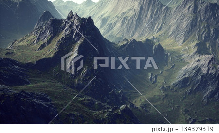 Winding valleys and towering peaks define this stunning mountain landscape, revealing natures beauty in a remote wilderness. Sunlight catches the rocky surfaces, creating a breathtaking view. 134379319