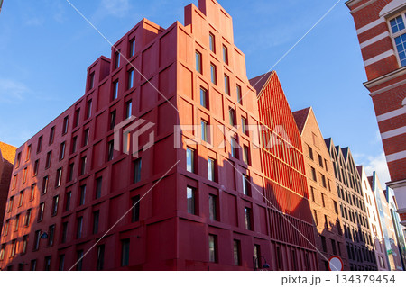 Modern building design in urban area with historical architecture nearby Modern building design in urban area with historical architecture nearby 134379454