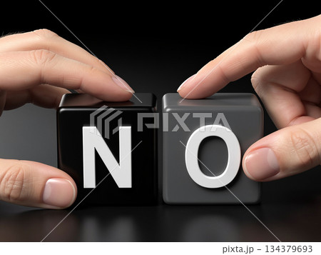 A conceptual image showing human hands interacting with black and gray cubes to form the word NO, symbolizing refusal, decision-making, and clear communication in business and daily life 134379693