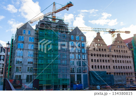 Construction site with cranes and buildings under development in the city 134380815