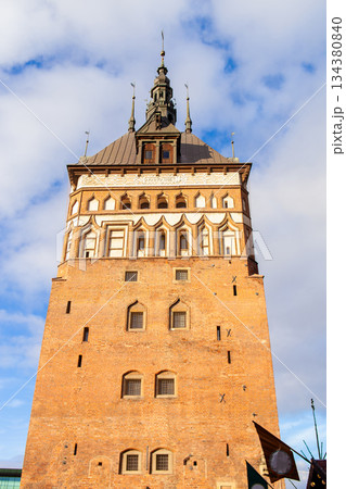 Historic tower in view against blue sky with clouds in city setting Historic tower in view against blue sky with clouds in city setting 134380840
