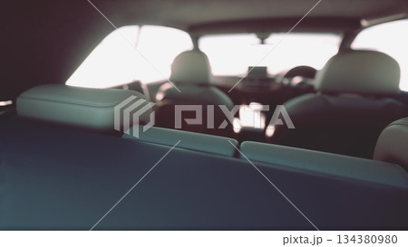 The interior of a stylish car is visible, highlighting comfortable seats and sleek finishes. Sunlight filters in, creating a warm and inviting atmosphere inside the vehicle. The interior of a stylish car is visible, highlighting comfortable seats and sleek finishes. Sunlight filters in, creating a warm and inviting atmosphere inside the vehicle. 134380980