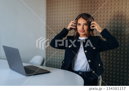 Woman is sitting and working by using laptop 134381157