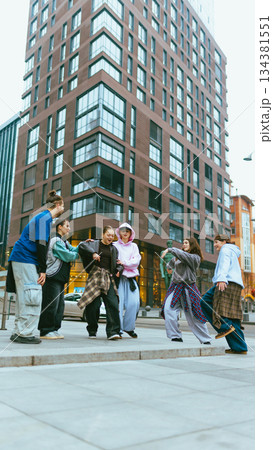 Hip hop dance crew showing confidence and collective energy outdoors. 134381551