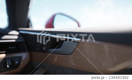 Inside a luxurious vehicle, a smooth wooden panel complements sleek metallic accents. Soft light pours in, highlighting the craftsmanship of the dashboard and door handle. Inside a luxurious vehicle, a smooth wooden panel complements sleek metallic accents. Soft light pours in, highlighting the craftsmanship of the dashboard and door handle. 134381562