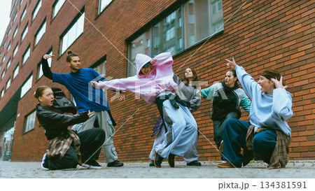 Hip hop dancers expressing attitude through coordinated movement. 134381591