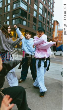 Young hip hop dancer in pink hoodie performing street routine Young hip hop dancer in pink hoodie performing street routine 134381601