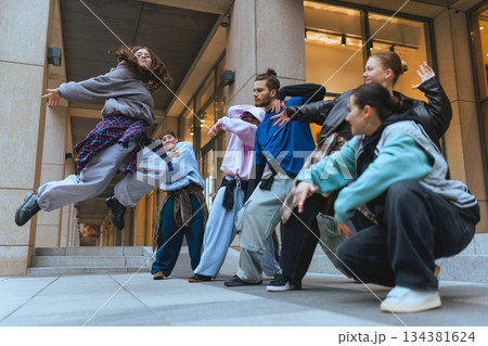Hip hop dancers training together in public space during practice session. 134381624