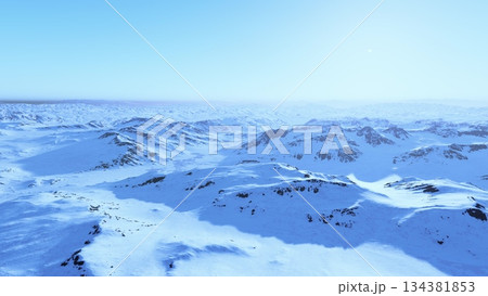 Snow blankets rolling mountains under a bright, clear sky. The crisp winter air pervades the serene scene, showcasing natures beauty in a tranquil, frosty realm. 134381853