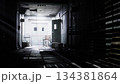 A dimly lit corridor stretches into the distance, shadows creeping along the walls. A single chair rests in the center, surrounded by scattered debris, evoking mystery and intrigue. 134381864