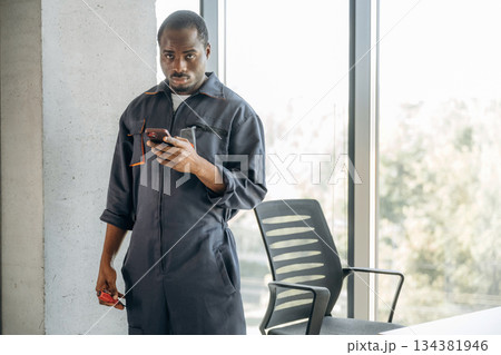 Repairman is indoors in the modern office Repairman is indoors in the modern office 134381946
