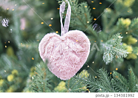 Christmas tree with pink fluffy soft heart in bokeh light decoration holiday decorations New year concept merry Christmas background greeting card Christmas tree with pink fluffy soft heart in bokeh light decoration holiday decorations New year concept merry Christmas background greeting card 134381992