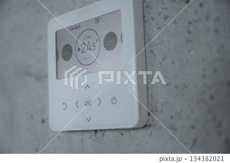 Thermostat on the wall, showing current temperature in the room Thermostat on the wall, showing current temperature in the room 134382021