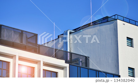 Office building in loft style. Facade of commercial office with windows. White walls of an industrial building. Office building in loft style. Facade of commercial office with windows. White walls of an industrial building. 134382040