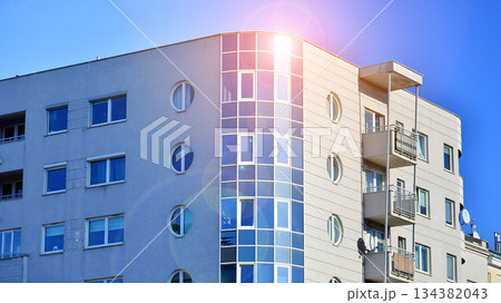 Office building in loft style. Facade of commercial office with windows. White walls of an industrial building. Office building in loft style. Facade of commercial office with windows. White walls of an industrial building. 134382043