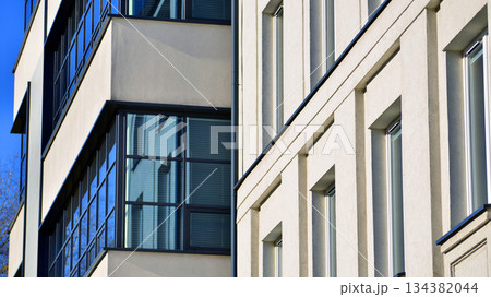 Office building in loft style. Facade of commercial office with windows. White walls of an industrial building. Office building in loft style. Facade of commercial office with windows. White walls of an industrial building. 134382044