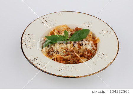 Pasta Bolognese with tomato sauce in white bowl on a white background Pasta Bolognese with tomato sauce in white bowl on a white background 134382563