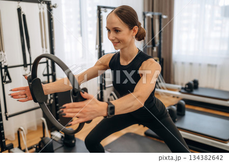 Young woman is in the gym with training equipment 134382642