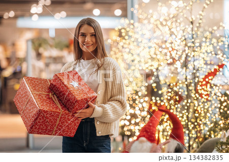 Gorgeous woman is with new year gifts near the Christmas tree Gorgeous woman is with new year gifts near the Christmas tree 134382835