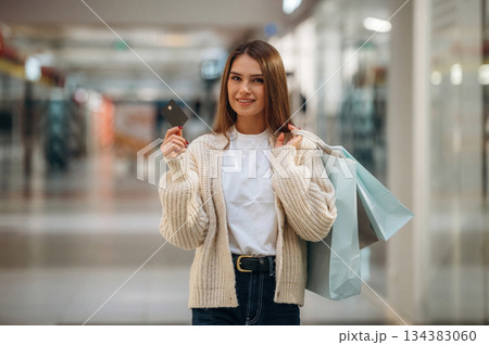 Holding credit card. Beautiful woman is in the mall, conception of shopping 134383060