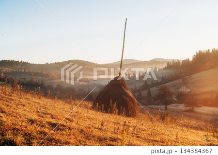Hay is on the field. Majestic view of Carpathian mountains, autumn season 134384367