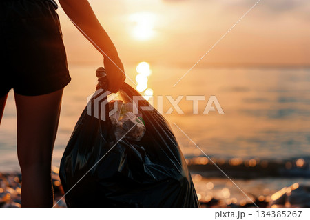 A person collects plastic wastes including bottle with empty space for text a concept of save the environment, Generative AI. A person collects plastic wastes including bottle with empty space for text a concept of save the environment, Generative AI. 134385267
