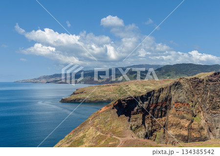 Wide coastal view from Sao Lourenco Madeira facing Funchal over calm sea and cliffs Wide coastal view from Sao Lourenco Madeira facing Funchal over calm sea and cliffs 134385542