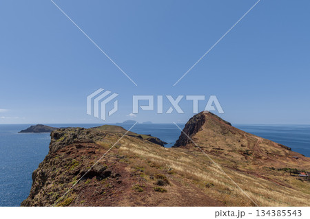 Dry volcanic ridge on Sao Lourenco Madeira with narrow hiking path toward islands 134385543