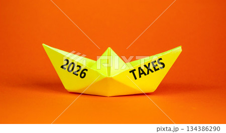 2026 taxes new year symbol. Concept words 2026 taxes on beautiful yellow paper boat. Beautiful orange paper background. Business and 2026 taxes new year concept. Copy space. 2026 taxes new year symbol. Concept words 2026 taxes on beautiful yellow paper boat. Beautiful orange paper background. Business and 2026 taxes new year concept. Copy space. 134386290