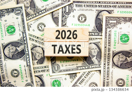 2026 taxes new year symbol. Concept words 2026 taxes on beautiful wooden blocks. Beautiful dollar bills background. Dollar bills. Business and 2026 taxes new year concept. Copy space. 134386634